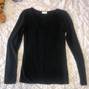 Long sleeve black shirt with v neck with cross.